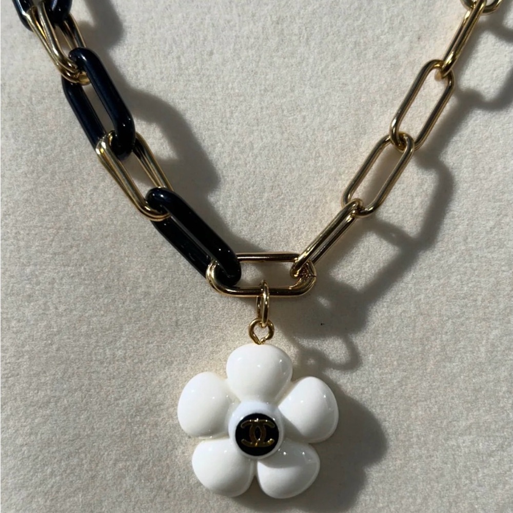 RARE ICON BLOOM 
Chanel White Camellia Pendant Necklace with Black & Gold Chain